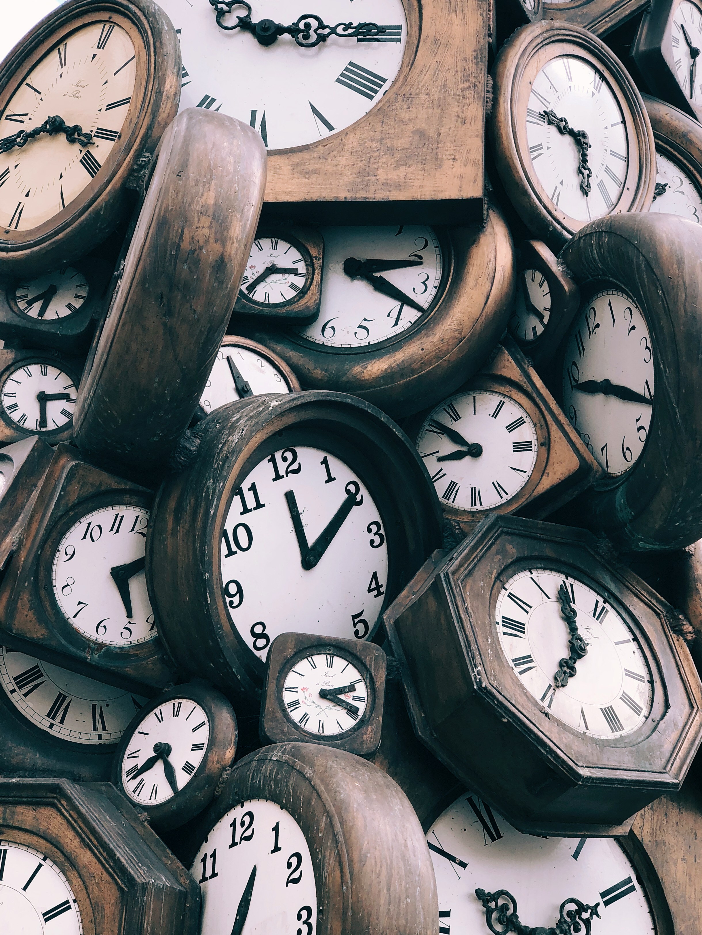 The invisible cost of founder-led research fatigue A pile of old clocks showing different times